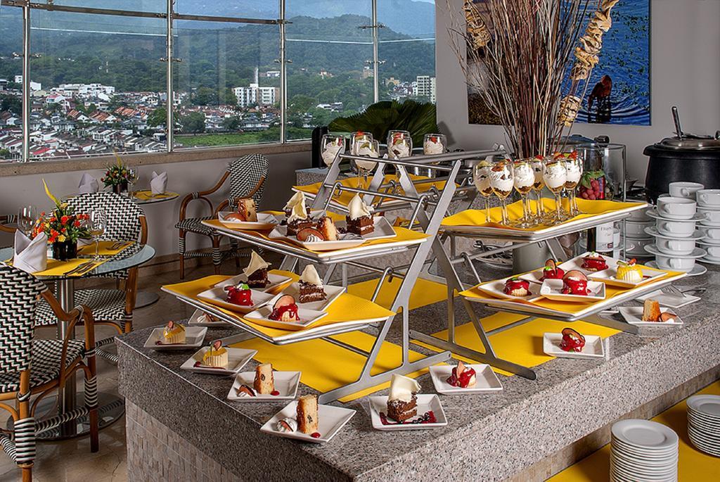 Ghl Hotel Grand Villavicencio Exterior photo A dessert buffet